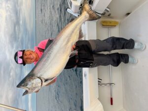 Captain Greta Gutschow holds a monster king salmon under her "cool" shades.